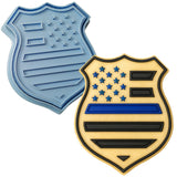 a cookie cutter and a cookie shaped like a shield