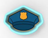 A blue police officer's hat with a yellow badge on it.