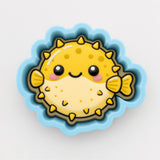 A cheerful yellow pufferfish with a smiling face, surrounded by a blue border, is depicted in the image.