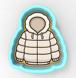 A cookie cutter in the shape of a winter coat with a hood.