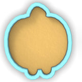 a cookie cutter with a cookie in the shape of a pumpkin