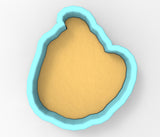 A blue-bordered cookie cutter with a yellow-colored interior, likely used for cutting cookies or other dough-based treats.