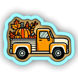 an orange truck with pumpkins in the back