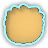 a cookie cutter with a cookie in the shape of a circle