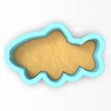 a cookie shaped like a fish on a white background