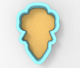 A blue cookie cutter in the shape of a flower, with a yellow center.