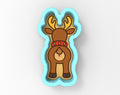 A cartoon image of a reindeer with antlers, wearing a red collar, and standing in a blue cookie cutter shape.