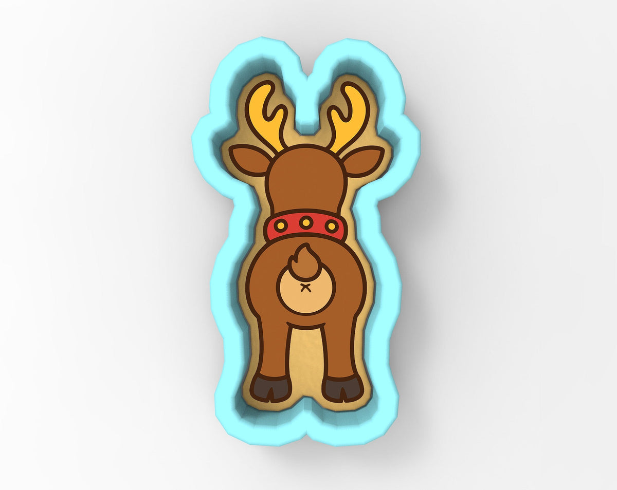 A cartoon image of a reindeer with antlers, wearing a red collar, and standing in a blue cookie cutter shape.