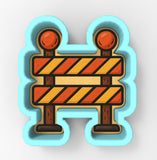 A blue and orange construction barrier with two orange balls on top, indicating a caution or warning sign.