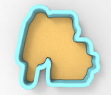 A 3D rendering of a cookie cutter in the shape of a house, with a light yellow interior and a blue exterior.