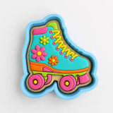 A cookie cutter shaped like a roller skate, with colorful flowers and wheels on it.