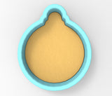 A blue cookie cutter with a yellow dough inside, designed for cutting dough into circular shapes.