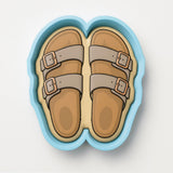 A pair of sandals in a blue and white container.