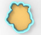 A blue cookie cutter in the shape of a head, with a light brown interior.