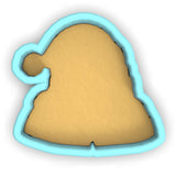 a cookie cutter with a cookie shaped like a santa hat