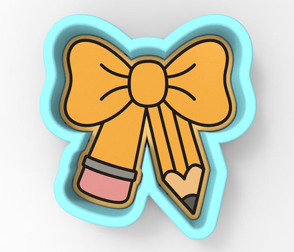 A blue cookie cutter shaped like a bow with a pencil on the side.