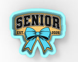 a blue ribbon with the word "SENIOR" written on it, along with the year "2026" below it.