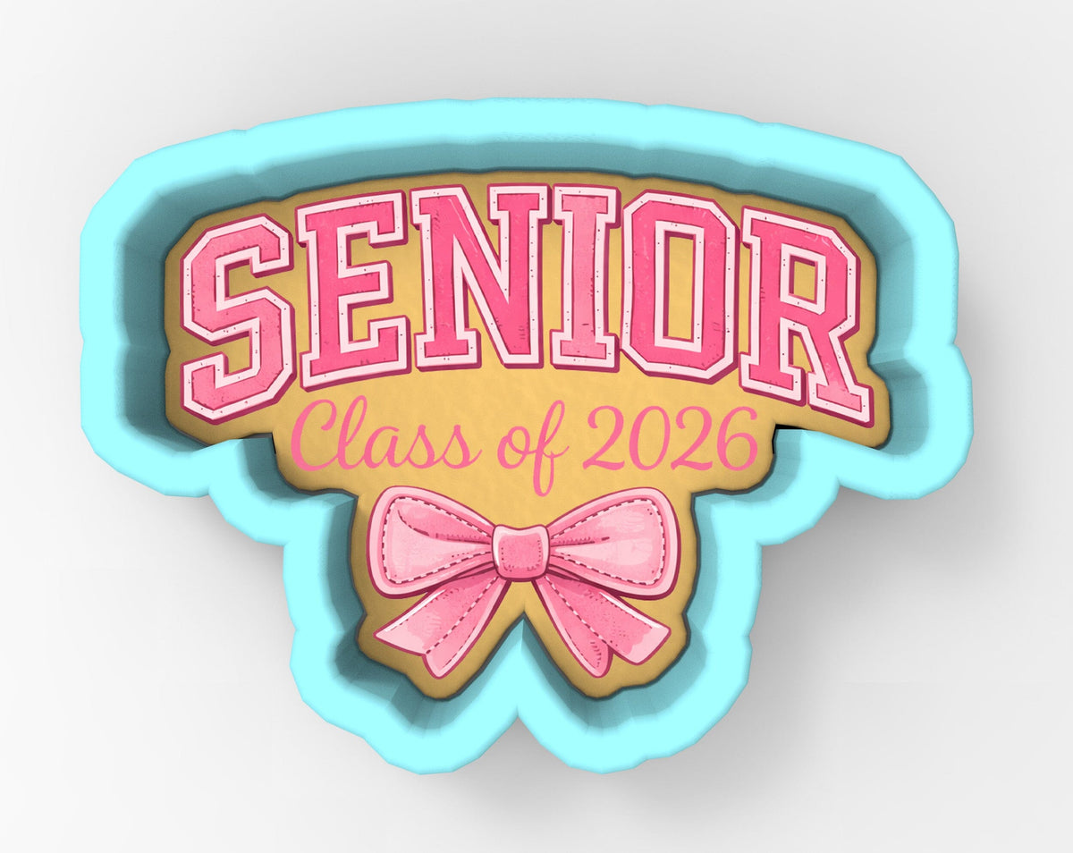 a cookie cutter shaped like the word "SENIOR" with a pink bow on it.