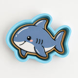 A blue and white cartoon fish cookie cutter.