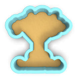a cookie cutter shaped like a mushroom on a white background