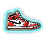 a sticker of a red and white shoe