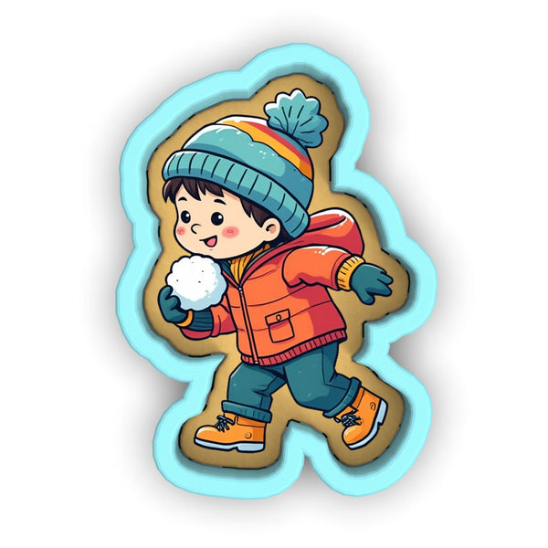 a sticker of a little boy wearing a winter coat and holding a snowball