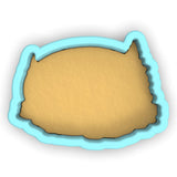 a cookie cutter with a cookie in the shape of a fish