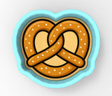 a plate with a pretzel in the shape of a heart