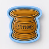A cookie cutter in the shape of a vase with the word "SPITToon" printed on it.