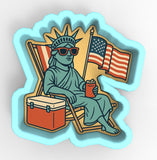a sticker of a statue of liberty sitting in a chair