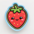 A cookie cutter shaped like a strawberry with a smiling face and green stem.