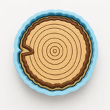A blue and brown cake pan with a tree trunk design on it.