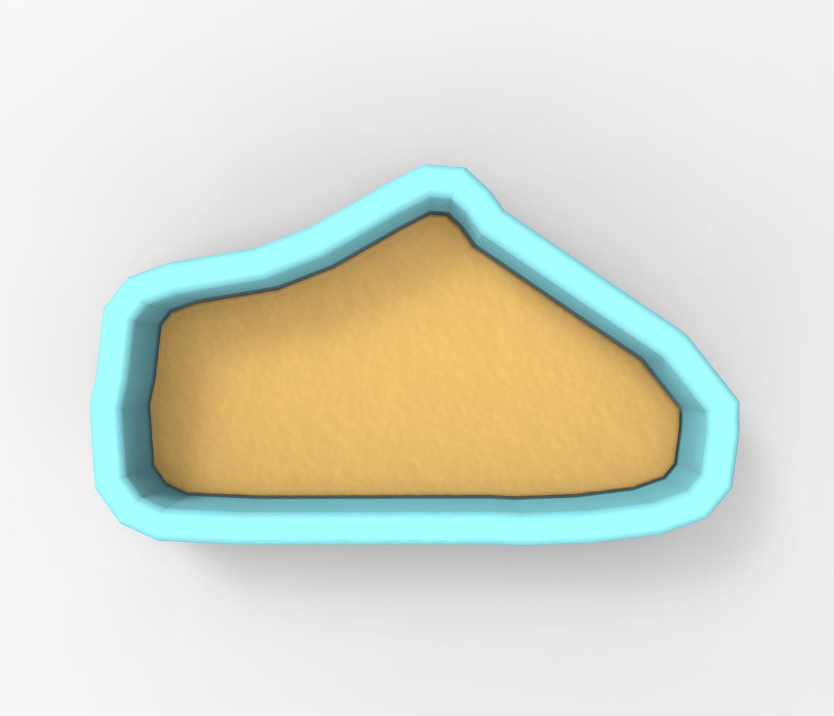 A blue-bordered, triangular-shaped object made of a light-colored material, possibly sand or clay.