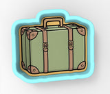 A green suitcase with brown straps is depicted in the image.