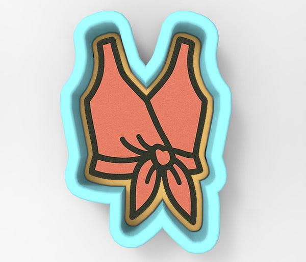 A cookie cutter in the shape of a vase with a pink flower design.
