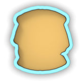 a cookie cutter with a cookie in the shape of a face