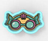 A pair of colorful, cartoon-style glasses with a seashell design on the top.