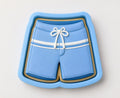 A blue cookie cutter shaped like a pair of blue swim shorts.