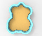 A 3D rendering of a teddy bear cookie cutter in a light blue shape.