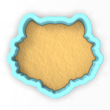 a cookie cutter with a cookie in the shape of a bear