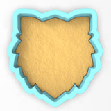 a cookie cutter shaped like a shield