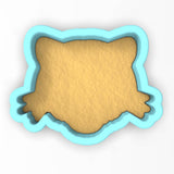 a cookie cutter with a cookie shaped like a bear