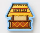 A blue cookie cutter shaped like a tiki bar, with the words "Tiki Bar" written on it.