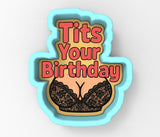 A cookie cutter-shaped image with the text "Tits Your Birthday" and a graphic of a bra.