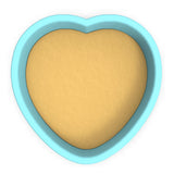 a heart shaped cookie cutter with a cookie inside of it