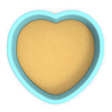 a heart shaped cookie cutter with a cookie inside of it