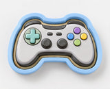 A 3D rendering of a video game controller with a blue and gray color scheme and various colored buttons.