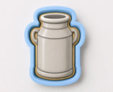 A cookie cutter in the shape of a milk can.