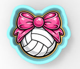 A volleyball with a pink bow on it.
