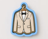 A cookie cutter in the shape of a suit with a bow tie, designed to represent formal attire.